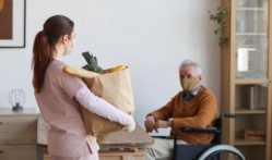 A female caregiver carrying groceries