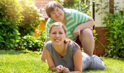 Two female smiling in their backyard