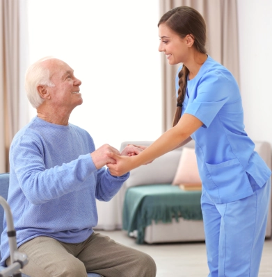 A female assisting a senior man to stand