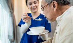 woman feeding grandpa